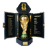Gold FIFA World Cup trophy in an open black case. Panels list past tournament winners and the 2026 host cities across Canada, Mexico, and the USA.