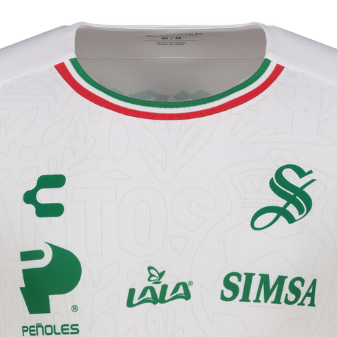 Close-up of a white Santos Laguna soccer jersey featuring green logos for Charly, Lala, Peñoles, and Simsa. The collar has red, white, and green stripes.