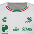 Close-up of a white Santos Laguna soccer jersey featuring green logos for Charly, Lala, Peñoles, and Simsa. The collar has red, white, and green stripes.