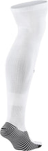 Side profile of a white knee-high athletic sock with black-and-white striped patterns on the heel and sole.