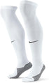 A pair of white Nike knee-high athletic socks featuring black swooshes on the shins and black-and-white striped grip patterns on the heels and soles.