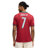 Back of a man wearing a red Portugal soccer jersey with "RONALDO 7" printed on the back. He has braided hair and wears light-colored shorts against a black background.