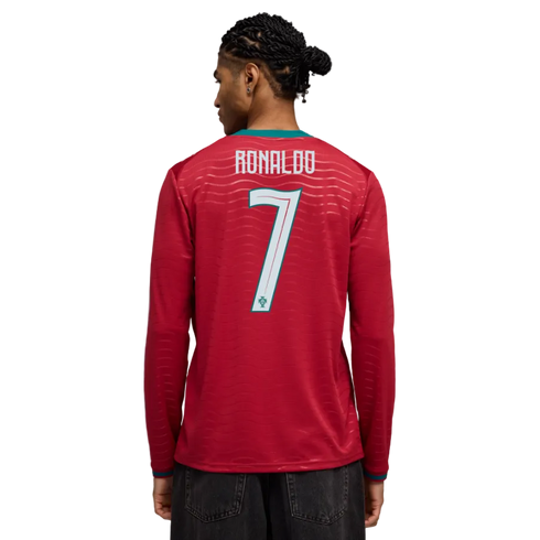 Rear view of a person in a red long-sleeved soccer jersey with "RONALDO 7" printed on the back. The person has dark braided hair and is wearing dark pants against a black background.