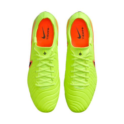 Aerial view of a pair of bright lime green Nike Tiempo soccer cleats with orange interiors, centered against a solid black background.