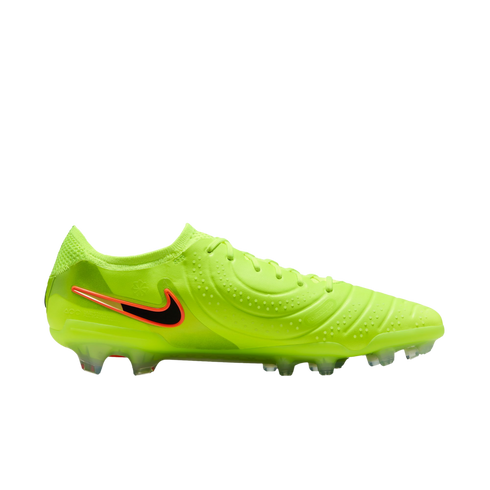 Side view of a lime green Nike soccer cleat with a black and orange swoosh and clear studs, set against a black background.