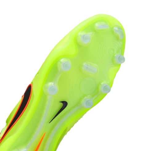 Neon yellow sole of a Nike soccer cleat with translucent studs and a small black swoosh.