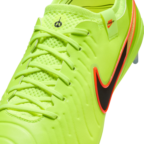 Close-up of a neon yellow Nike Tiempo soccer cleat with a black and orange swoosh, textured upper, and light yellow laces.