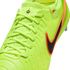 Close-up of a neon yellow Nike Tiempo soccer cleat with a black and orange swoosh, textured upper, and light yellow laces.