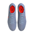 Top-down view of a pair of light blue Nike Tiempo soccer cleats with bright orange insoles and black branding, set against a solid black background.