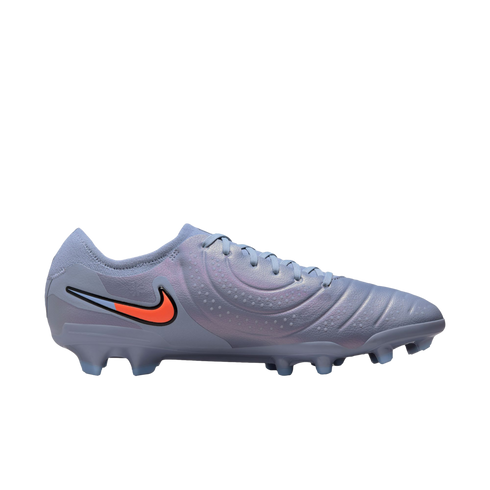 Side profile of an iridescent light blue Nike soccer cleat with a bright orange swoosh logo on a solid black background.
