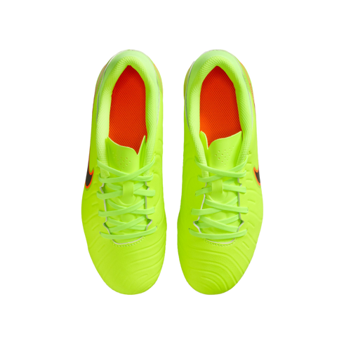 Top-down view of a pair of bright neon yellow Nike soccer cleats with orange insoles on a black background.