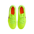 Top-down view of a pair of bright neon yellow Nike soccer cleats with orange insoles on a black background.