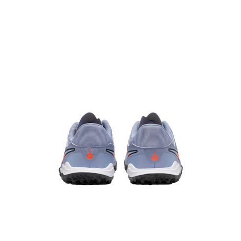 Rear view of light blue athletic shoes with orange accents, white midsoles, and black studded outsoles against a black background.