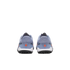 Rear view of light blue athletic shoes with orange accents, white midsoles, and black studded outsoles against a black background.