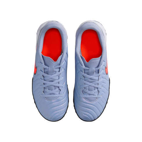 Top-down view of a pair of light blue Nike athletic shoes with bright orange interiors and orange Nike swooshes, set against a solid black background.