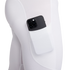 Close-up of a black smartphone tucked into the side pocket of white athletic leggings.