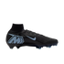 Profile of a black Nike Mercurial soccer cleat with light blue accents, a high-top collar, and a large "M" logo on the heel, shown against a black background.