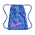 A blue Nike drawstring bag featuring a white multilingual text pattern and a large, vibrant pink Nike swoosh logo on the front.
