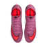 Top-down view of purple Nike Mercurial soccer cleats with bright red swooshes and laces on a black background.