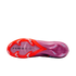 Underside view of a pink and orange soccer cleat featuring "AIR ZOOM" text and various studs against a solid black background.