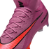 Close-up of a pink Nike soccer cleat with a textured knit upper, bright orange swoosh, and pink laces.
