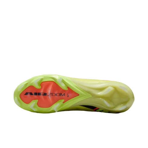 Bottom view of a lime green soccer cleat showing an orange plate with "AIR ZOOM" branding and white studs on a black background.