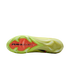 Bottom view of a lime green soccer cleat showing an orange plate with "AIR ZOOM" branding and white studs on a black background.