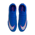 Top-down view of blue Nike Mercurial soccer cleats with white and pink accents, featuring large white swooshes on the toes, against a black background.