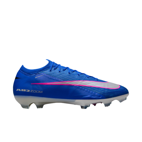 A blue Nike soccer cleat with a silver swoosh outlined in pink. The shoe features white "AIR ZOOM" branding on the side and a white, translucent cleated sole against a black background.