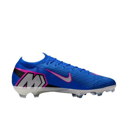 A side profile of a bright blue Nike soccer cleat with a pink-trimmed silver swoosh and a large "M" logo on the heel, set against a black background.