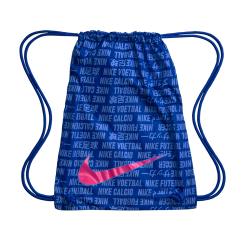 A blue Nike drawstring bag with a large metallic pink swoosh over a repeating pattern of the word "soccer" in multiple languages.