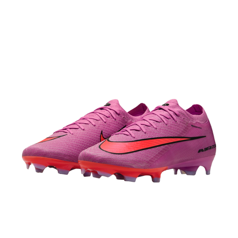 Pair of pink Nike Air Zoom soccer cleats with a vibrant red swoosh and sole plate, isolated on a black background.