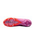 Underside view of a pink and orange Nike soccer cleat with "AIR ZOOM" branding and translucent studs, set against a solid black background.