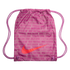 Pink Nike drawstring gym bag with a large orange swoosh logo and an all-over text pattern of "Nike" and international translations for "soccer."