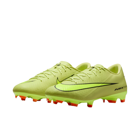 Neon yellow Nike soccer cleats with a textured upper, black swoosh, and orange studs, set against a black background.