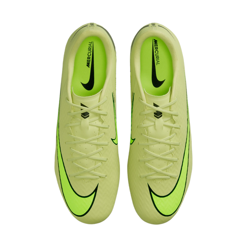 A top-down view of a pair of lime green Nike Mercurial soccer cleats with black swooshes and neon green accents against a black background.