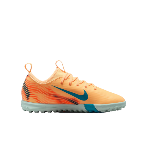 Nike soccer shoe in bright peach with a teal swoosh and a light grey textured outsole.