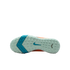 Sole of a light green Nike soccer shoe with small studs, a teal swoosh, and a blue chevron pattern on the forefoot, set against a black background.