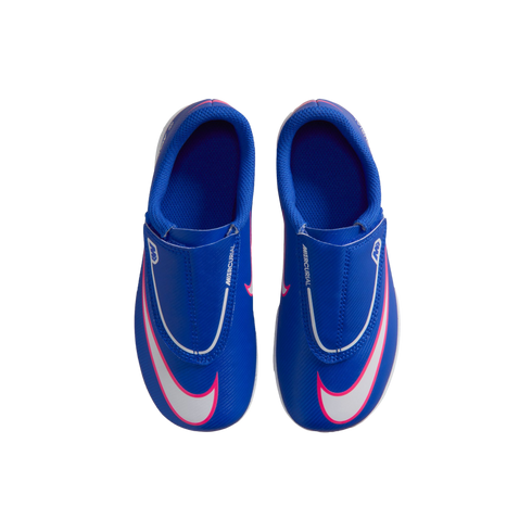 Top-down view of blue Nike Mercurial soccer cleats with large white swooshes and pink outlines against a solid black background.