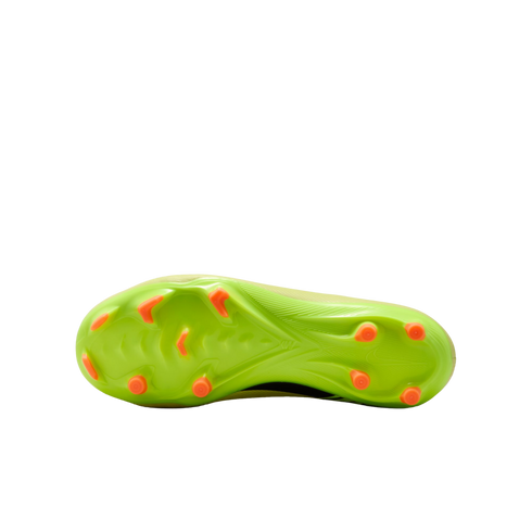 Neon green Nike soccer cleat soleplate with bright orange studs against a black background.