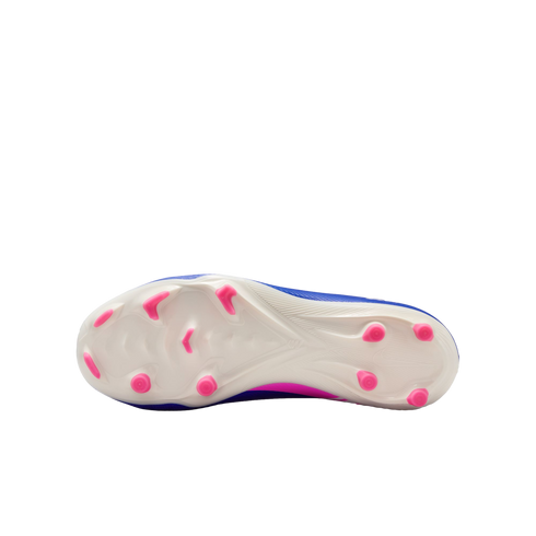 The white sole of a blue and pink soccer cleat, featuring bright pink studs against a solid black background.