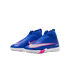 A pair of bright blue Nike Air Zoom soccer turf shoes with pink accents, silver Swooshes, and white soles, set against a black background.
