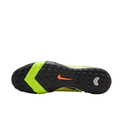 Bottom of a black and lime green Nike turf soccer shoe showing the studded rubber outsole and orange swoosh logo.