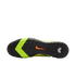 Bottom of a black and lime green Nike turf soccer shoe showing the studded rubber outsole and orange swoosh logo.