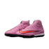 A pair of pink Nike Mercurial Superfly soccer turf shoes with a bold red swoosh, high-top collar, and black outsole on a black background.