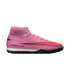 A pink Nike Air Zoom Mercurial soccer shoe with a large red swoosh, high-top collar, and black textured sole against a black background.