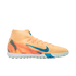 A peach-colored Nike turf soccer shoe with blue accents and a high-top collar, shown in profile against a black background.