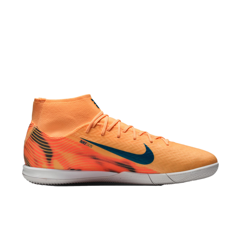 An orange Nike high-top indoor soccer shoe with a blue swoosh and patterned heel, shown in profile against a black background.