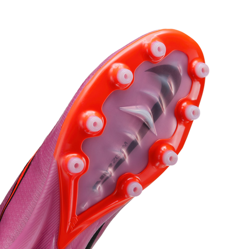 Bottom of a pink Nike soccer cleat showing an orange sole plate with translucent studs and the "Air Zoom" logo visible through the center of the plate.