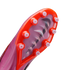Bottom of a pink Nike soccer cleat showing an orange sole plate with translucent studs and the "Air Zoom" logo visible through the center of the plate.